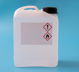 plastic canister with hazard symbols on blue background