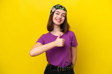 Young Ukrainian woman isolated on yellow background giving a thumbs up gesture