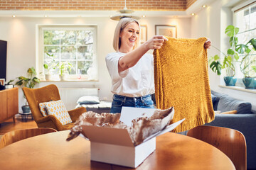 Mid adult woman looking on clothes ordered online