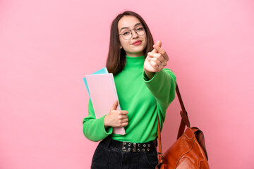 Young student Ukrainian woman isolated on pink background making money gesture