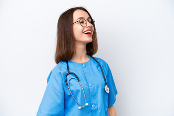 Young nurse Ukrainian woman isolated on white background laughing in lateral position