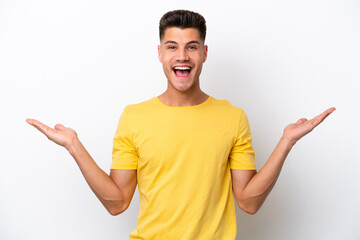 Young caucasian man isolated on white background with shocked facial expression