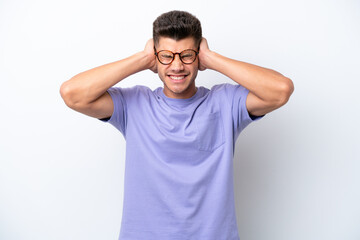 Fototapeta premium Young caucasian man isolated on white background frustrated and covering ears