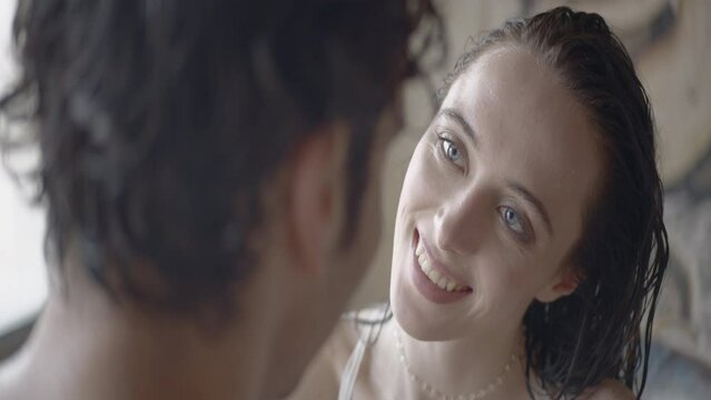 Sensual couple enjoying and touching each other. Action. Sexy female with wet hair and male embracing her, lovers enjoying sexual sensation.