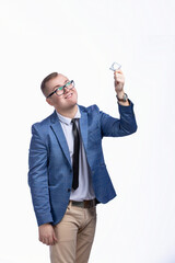 Young guy in a jacket, bow tie, glasses holds a condom in his hand. Isolated on white background