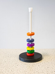 Colored magnetic rings around a rod float above each other due to the repulsive magnetic force....