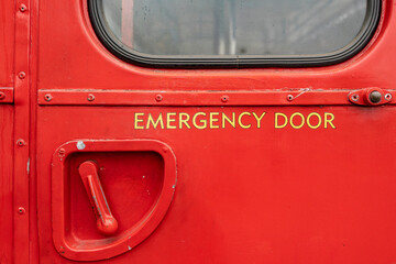 rear emergency door and handle on a red double decker bus