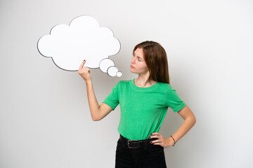 Young English woman isolated on white background holding an empty speech bubble