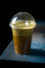 Vegetarian smoothie spirulina on dark style on blue table vertical