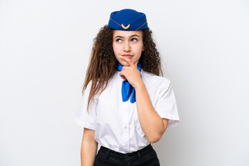 Airplane stewardess Arab woman isolated on white background having doubts and with confuse face expression