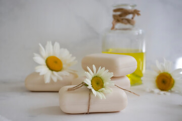 Fototapeta na wymiar natural soap, chamomile flower on a light background
