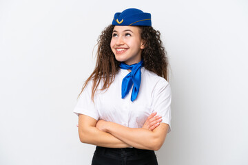 Airplane stewardess Arab woman isolated on white background looking up while smiling