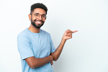 Young Brazilian man isolated on white background pointing finger to the side
