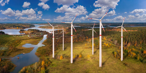 Environmentally friendly power plant. Power plant in forest with lakes. Windmills view from...