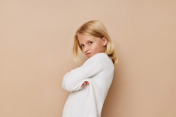 Little cute girl with blond hair posing studio