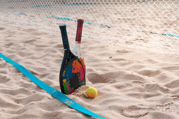 Beach tennis rackets and balls on the beach sand