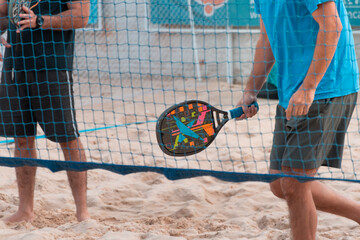 Beach tennis racket in hand
