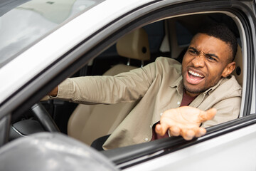 Side view of an angry black man driving a car
