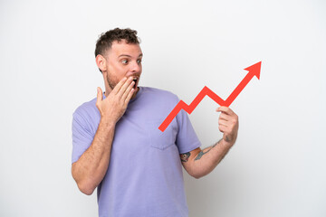 Young Brazilian man isolated on white background holding a catching a rising arrow with surprised expression