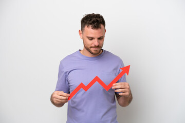 Young Brazilian man isolated on white background holding a catching a rising arrow with happy expression