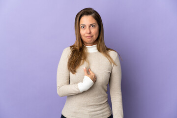 Middle age Brazilian woman isolated on purple background pointing to oneself