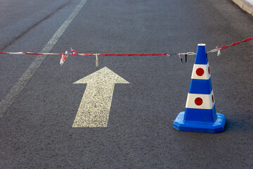 a roadblock with a road cone and a chain