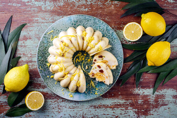 Traditional Italian budino di ricotta cheese pudding cake with raisins and lemon creme served as top view on a design plate with cottage style decoration