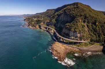 Aerial view of Sea cliff bridge at the edge of steep sandstone cliff on the Grand Pacific drive along pacific coast of Australia, NSW.