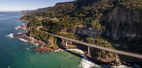 Aerial view of Sea cliff bridge at the edge of steep sandstone cliff on the Grand Pacific drive along pacific coast of Australia, NSW.