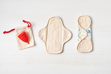 Zero waste periods kit. Eco friendly feminine hygiene, reuse concept. Reusable sanitary pads and menstrual cup for personal hygiene. Waste-free lifestyle. © netrun78