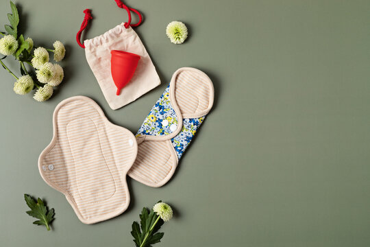 Zero waste periods kit. Eco friendly feminine hygiene, reuse concept. Reusable sanitary pads and menstrual cup for personal hygiene. Waste-free lifestyle.
