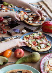 Kid take avocado pizza on table