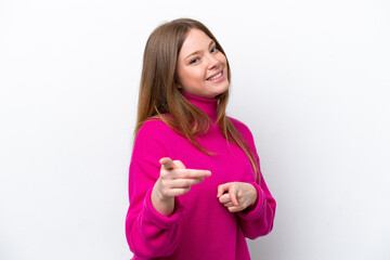 Young caucasian woman isolated on white background surprised and pointing front