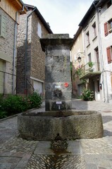 Fototapeta na wymiar Fountain in the medieval village of Desaignes in Ardeche in France, Europe