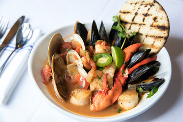 seafood bouillabaisse with mussels, clams, scallops and lobster - obrazy, fototapety, plakaty