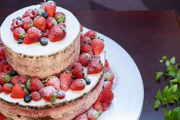 Two-tiered original cake with lots of strawberries