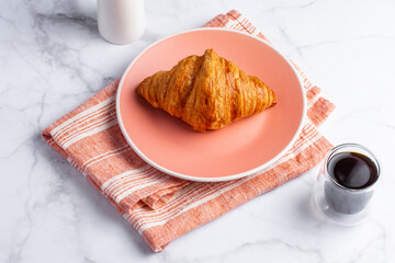 croissant and coffee on a light background