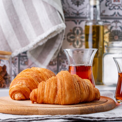croissant and black tea in a turkish cup