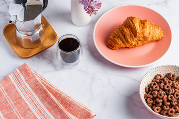 croissant and coffee on a light background