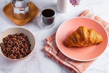 croissant and coffee on a light background