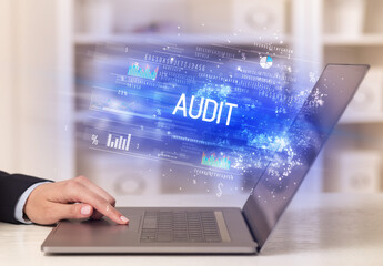 Closeup of businessman hands working on laptop