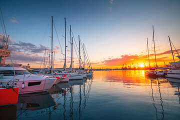 Yacht port and beautiful sunset over Varna, Bulgaria. Sailboat harbor, many beautiful moored sail yachts in the sea