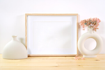 Art print horizontal frame product mockup. Boho theme craft product mockup styled with Scandinavian Boho Nordic ceramic vases against a white background.
