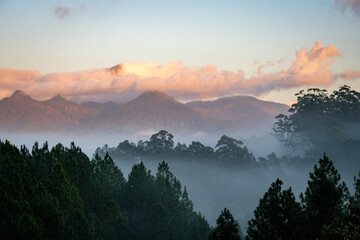 Foggy sunrise over Wollumbin Mt Warning with fog in valley