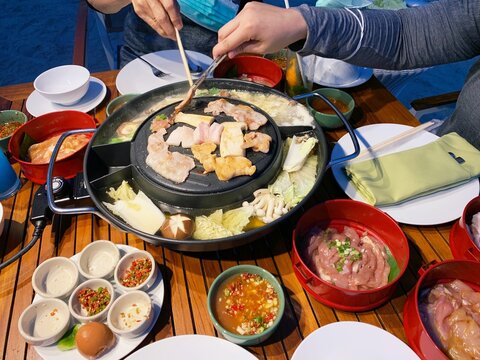 grill pork on hot pan plate. Japanese or Korean Cuisine Jingisukan or Yakiniku barbecue. Thai traditional barbecue roasted buffet. Enjoy eating lifestyle concept.