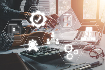 Quality management with QA (assurance), QC (control) and improvement, Business team discussing data with document data with VR screen quality management icon on desk table..