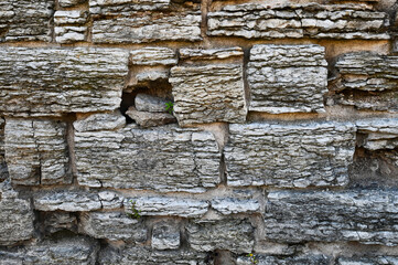 Chalky Stone Bricks in a Wall with Open Space Filled by Rocks Pattern and Texture Background