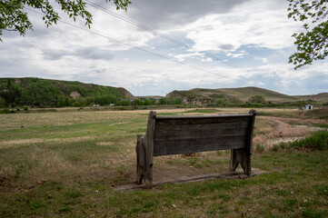Old wooden church pew looking over the badlands.