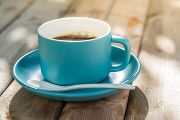 blue ceramic coffee cup on the old wooden floor.