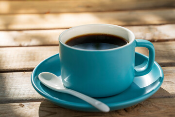 blue ceramic coffee cup on the old wooden floor.